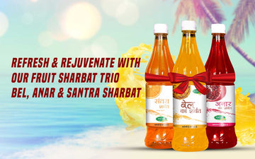 Swadeshi Fruit Sharbat Trio - Bel, Anar & Santra Sharbat bottles displayed on a rustic wooden table with fresh fruits in the background.